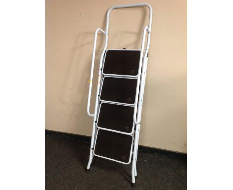 A four tread folding step ladder with twin hand rail 