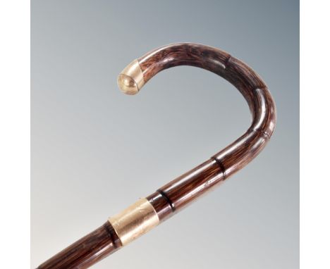 A vintage walking stick with 9 carat gold mounts. 