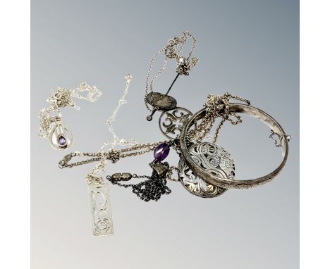 A group of silver pendants, bangle etc. 