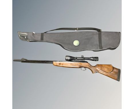 A air rifle with Bushmaster 4 x 40 scope, carry bag and tin of pellets, .22 calibre CONDITION REPORT: No maker's mark. 