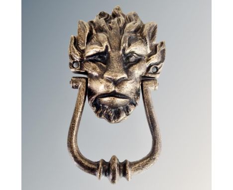 A cast iron lion's head door knocker.