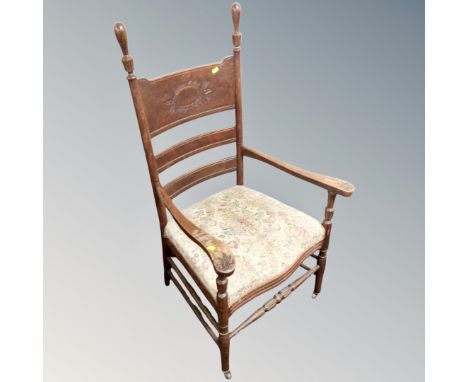 A carved oak panel backed Arts and Crafts armchair 