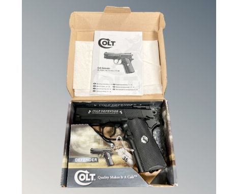 A Colt Defender .177 CO2 powered air pistol in original box with manual.