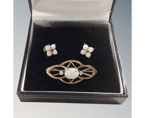 A 14 carat gold and opal bar brooch with matching earnings. 