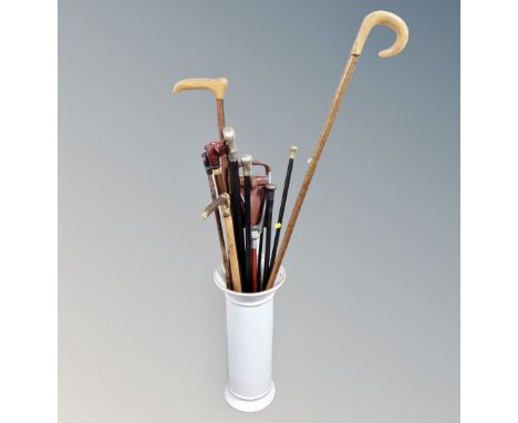 A ceramic stick stand containing walking sticks, canes, Shepherd's crooks including silver and animal head examples, shooting