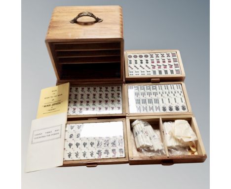 A Mahjong set, in a wooden five-drawer chest. 