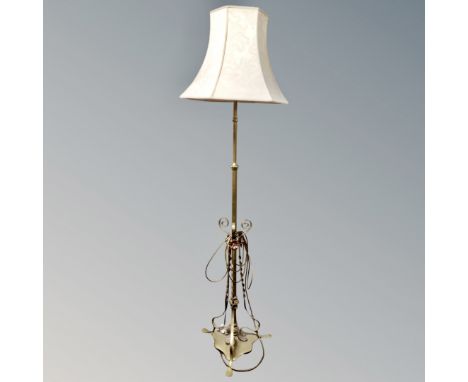 A brass and copper Art Nouveau standard lamp with shade 