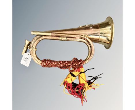 A copper and brass bugle with artillery badge and tassels 