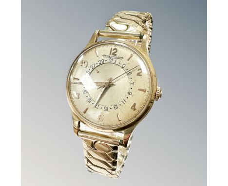 A gent's vintage 18ct gold Jaeger LeCoultre manual-wind calendar wristwatch, the cream dial with Arabic and baton markers, gi