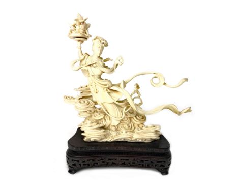 EARLY 20TH CENTURY CHINESE IVORY CARVING OF ZHINU, modelled as the mythical goddess weaving clouds and holding aloft a tray o