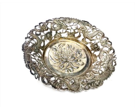 CHINESE SILVER CIRCULAR DISH, with a raised border pierced with dragon designs, the centre embossed with flowers, stamped 90 
