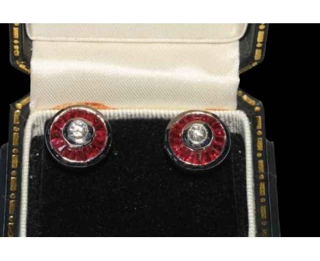 Pair ruby and diamond 18 carat white gold earrings, each having approximately 0.3 carat diamond bordered with pavé rubies.