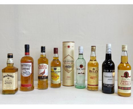 A mixed collection of unopened bottled whisky, rum and sherry to include Jack Daniels, Southern Comfort, The Famous Grouse, M