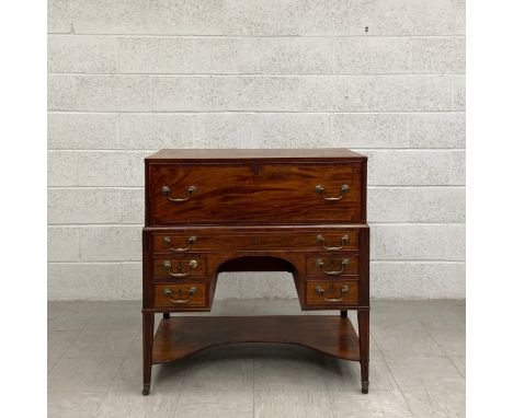A Georgian mahogany campaign style kneehole writing desk in two parts having a rectangular inlaid top over a fall front fabri