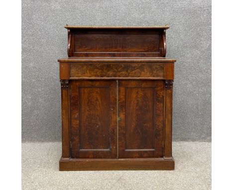 A 19th century flame mahogany chiffonier having a shallow open top shelf with a pierced brass gallery back on scrolled suppor