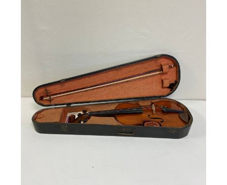 A 19th century violin labelled Antonius Stradivarius Deutsche Arbeit 1886' with a two piece back completed with bow in a fitt