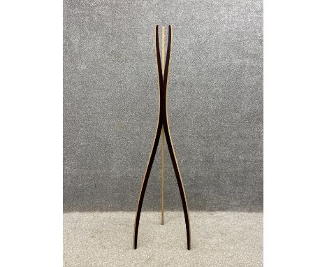 A contemporary plywood coat stand of curvilinear form with raw and black faceted sides on a tapering tripod base by UntoThisL