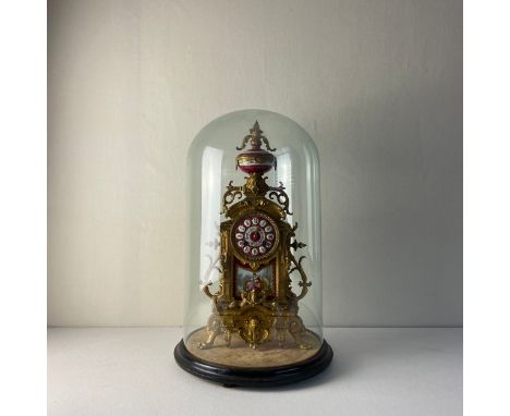 A large 19th century French gilt metal mantle clock in the Rococo style having a hand painted ceramic dial with floral decora