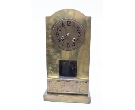 A arts & crafts style brass mantel clock with 2 train spring driven movement, striking on a bell. Contained in a brass case w