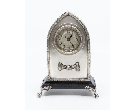 A small arts & crafts style ebonised & silver metal mantel clock, with 8 day spring driven movement 2" silver dial.Dimensions