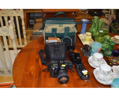 A Nikon D90 camera and lens with flash and remote etc.