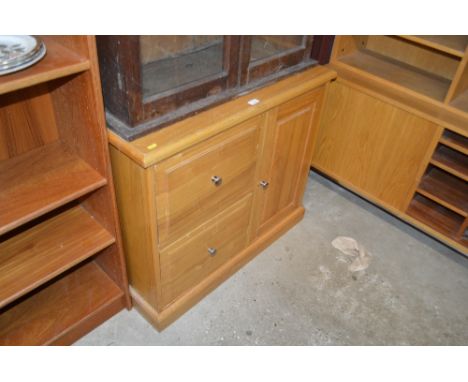 A light oak veneered side cupboard fitted two drawers 