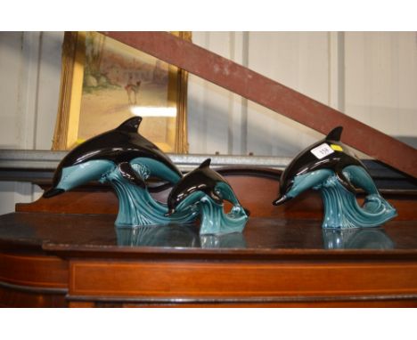 Three Poole pottery dolphins