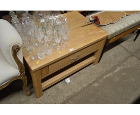 A light oak veneered coffee table fitted single drawer 