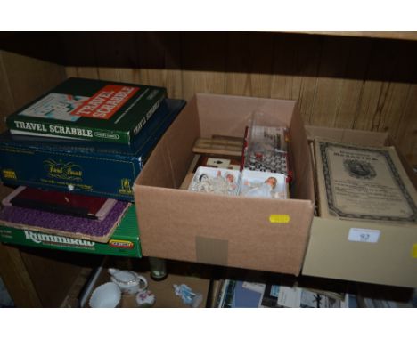 Two boxes and a collection of various games, dominoes, cribbage board, three miniature dolls etc.