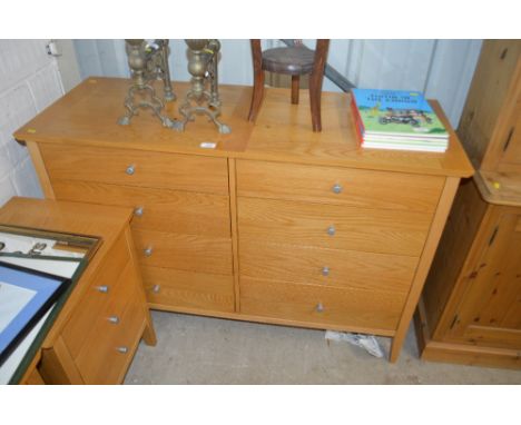 A light oak veneered eight drawer sideboard 