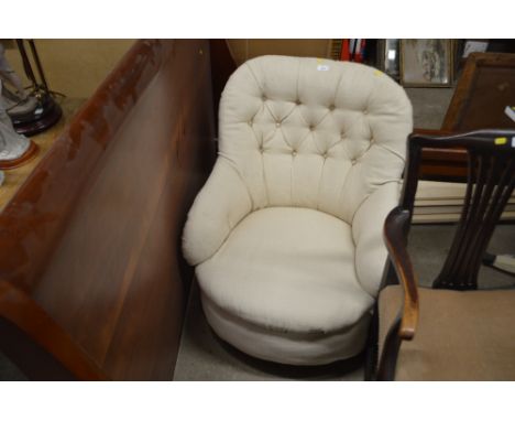 An upholstered button back armchair 