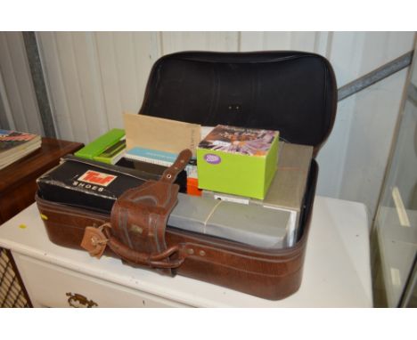 A suitcase of projector slides with information