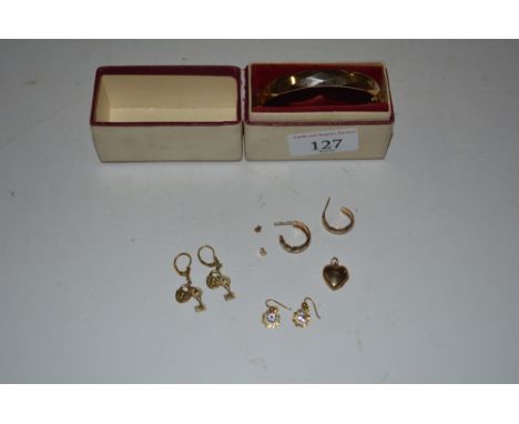 A gold plated bangle; and a quantity of ear-rings 