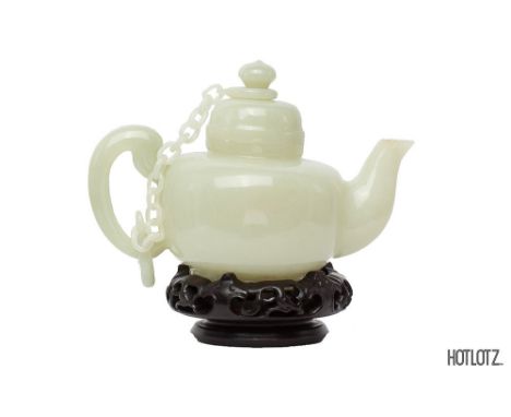 A CHINESE JADE PEDESTAL CENSER AND COVER
With drop ring handles and relief carved decoration 27cm high x 16.6cm wide x 23cm l