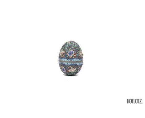 A RUSSIAN SILVER AND CLOISONNE ENAMEL EGG
Decorated with scrolling foliage in shaded enamels, gilt interior 10 cm high, 183 g