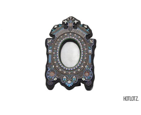 A RUSSIAN CLOISONNE ENAMEL PHOTOGRAPH FRAME
Apparently unmarked, of shaped outline with oval aperture, with easel strut back 