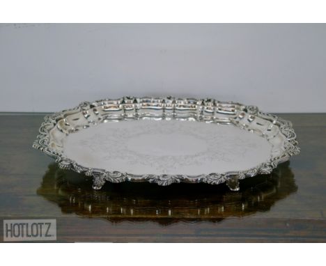 A LARGE SPANISH SILVER SALVER
916 standard, retailer by Joyeria Agruna, Madrid
Shaped oval with foliate engraving and Rococo 