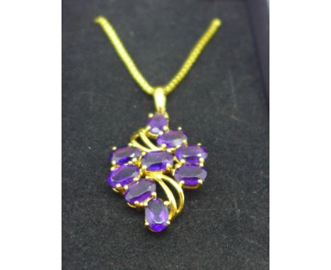 A silver gilt and amethyst pendant on chain 