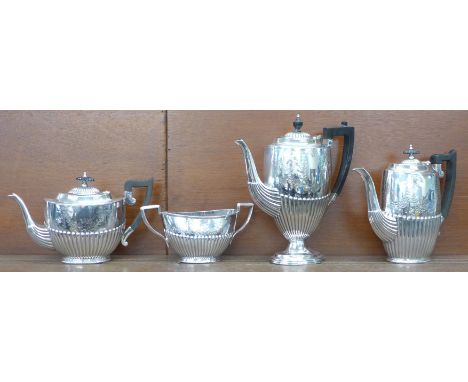 A three piece silver plated tea service and a plated coffee pot 