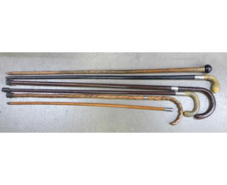 Four silver mounted sticks, a walking cane and a swagger stick 