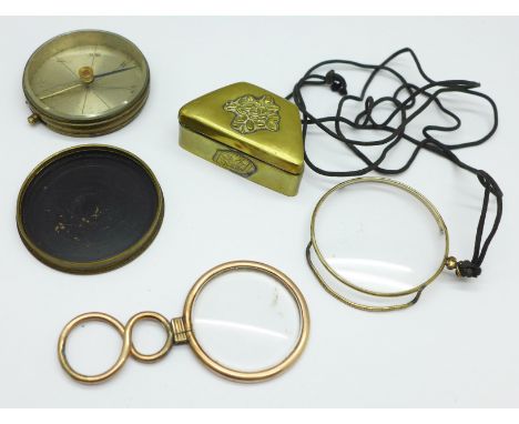 A compass, marked made in France, a pill box and two eye glasses 