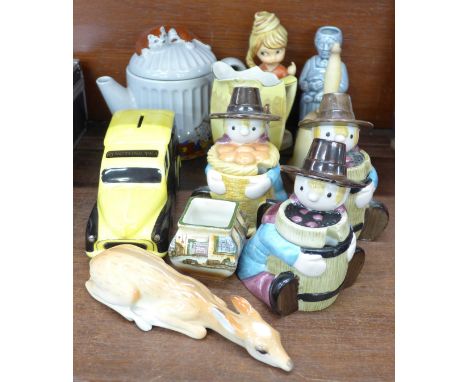 A Goebel bell, a German figure, three novelty Camberwick Green condiments, a Royal Doulton Shylock jug, a Wade cat teapot, et