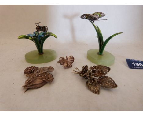 Three items of silver filigree jewellery, together with two enamel on metal plant ornaments each with an insect on green ston