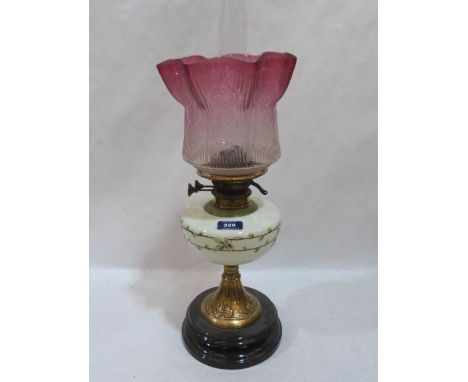 A Victorian oillamp with milch-glass fount painted with flowers and ruby flashed acid etched shade (chipped) on brass and sla