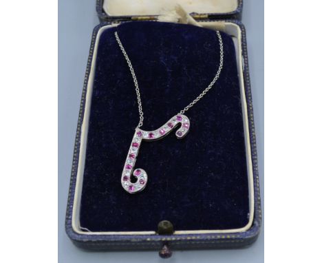 A white metal diamond and Ruby set pendant with fine linked chain and within blue velvet lined case 