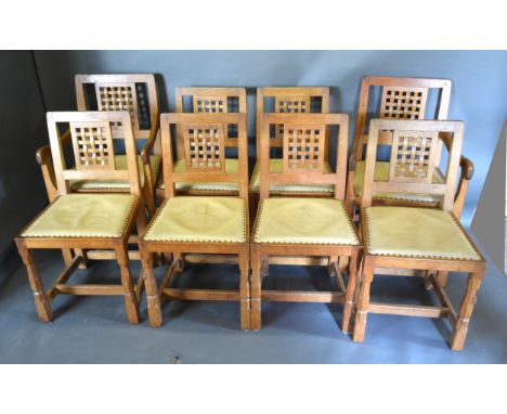 Robert (Mouseman) Thompson, A Set Of Eight (two arms and six singles) Oak Dining Chairs each with a lattice back above a bras