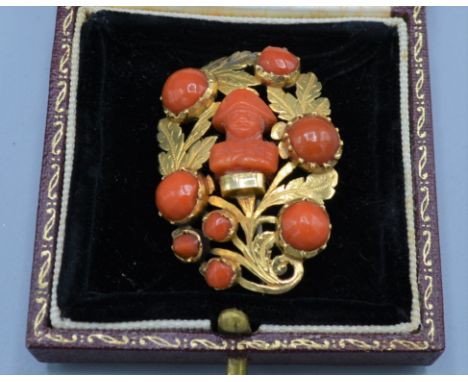 A 19th Century yellow metal and coral set brooch with central coral bust depicting Napoleon, 8.6 grams, 4cms long 