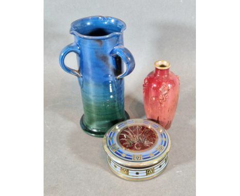 A Pilkington Royal Lancastrian small vase, 11cms tall together with a circular covered box and a three handled jug vase by A 