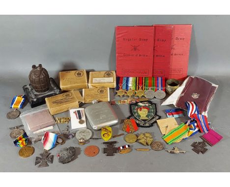 A first world war mounted grenade together with a collection of related items to include medals and paperwork 