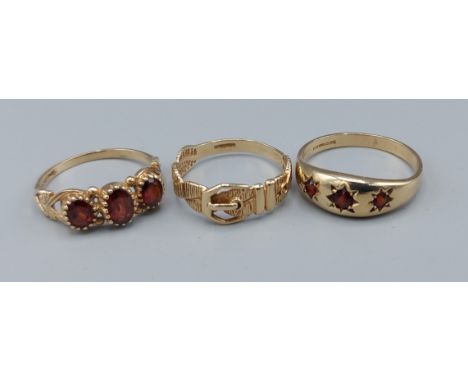A 9ct gold ring set with three Garnets together with another similar and a 9ct gold ring in the form of a buckle, 6.2 grams 